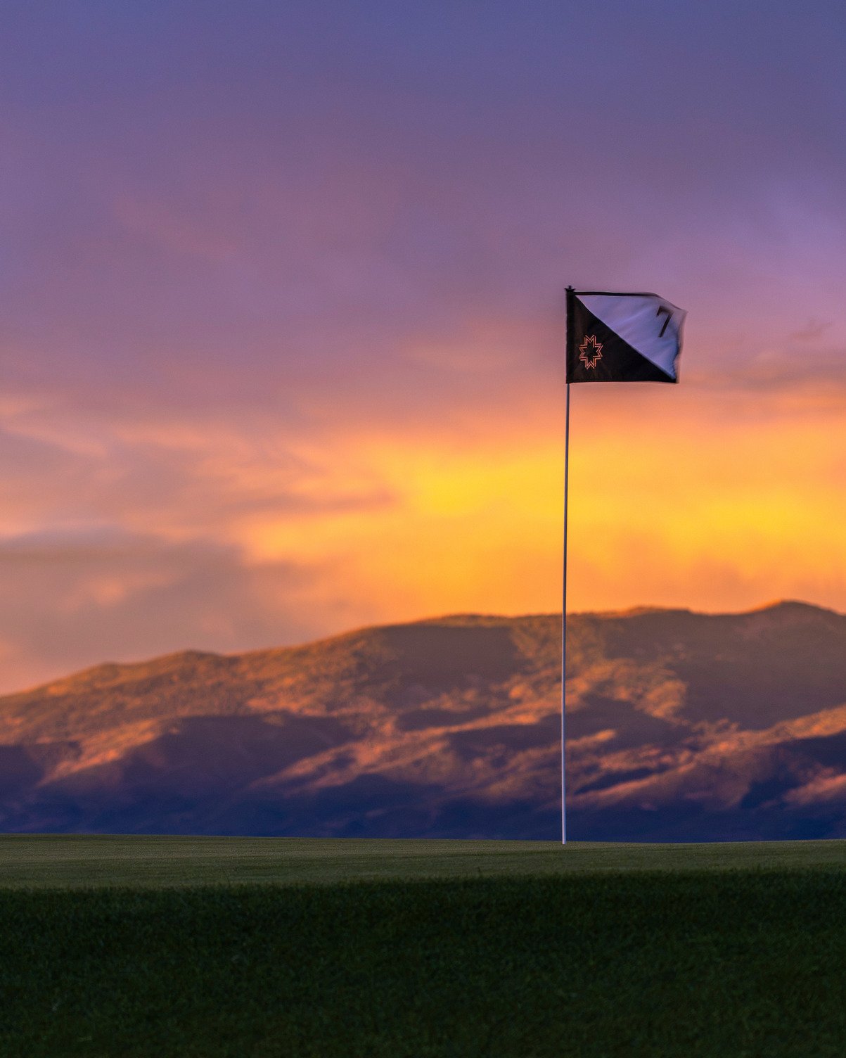 Marcella pin flag at dusk, Wasatch ridgeline beyond